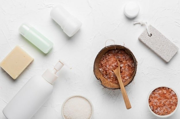 A flat lay of various skincare products, including a cleanser, exfoliant scrub, toner, and moisturizer. The products are arranged neatly on a clean white background.